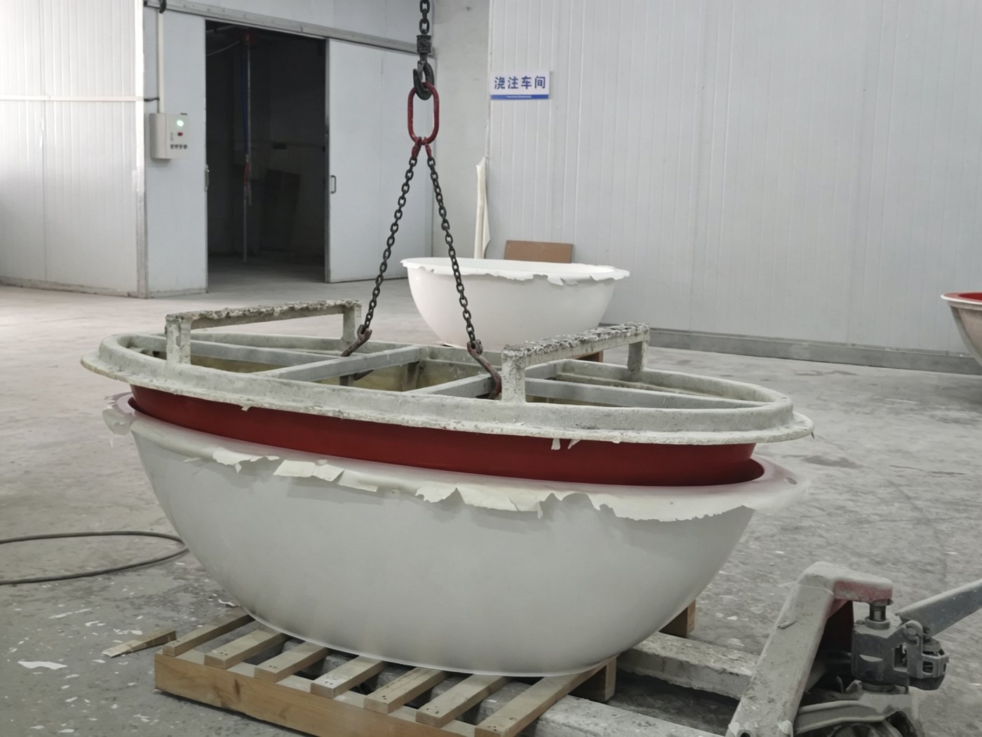 Worker demoulding a solid surface bathtub